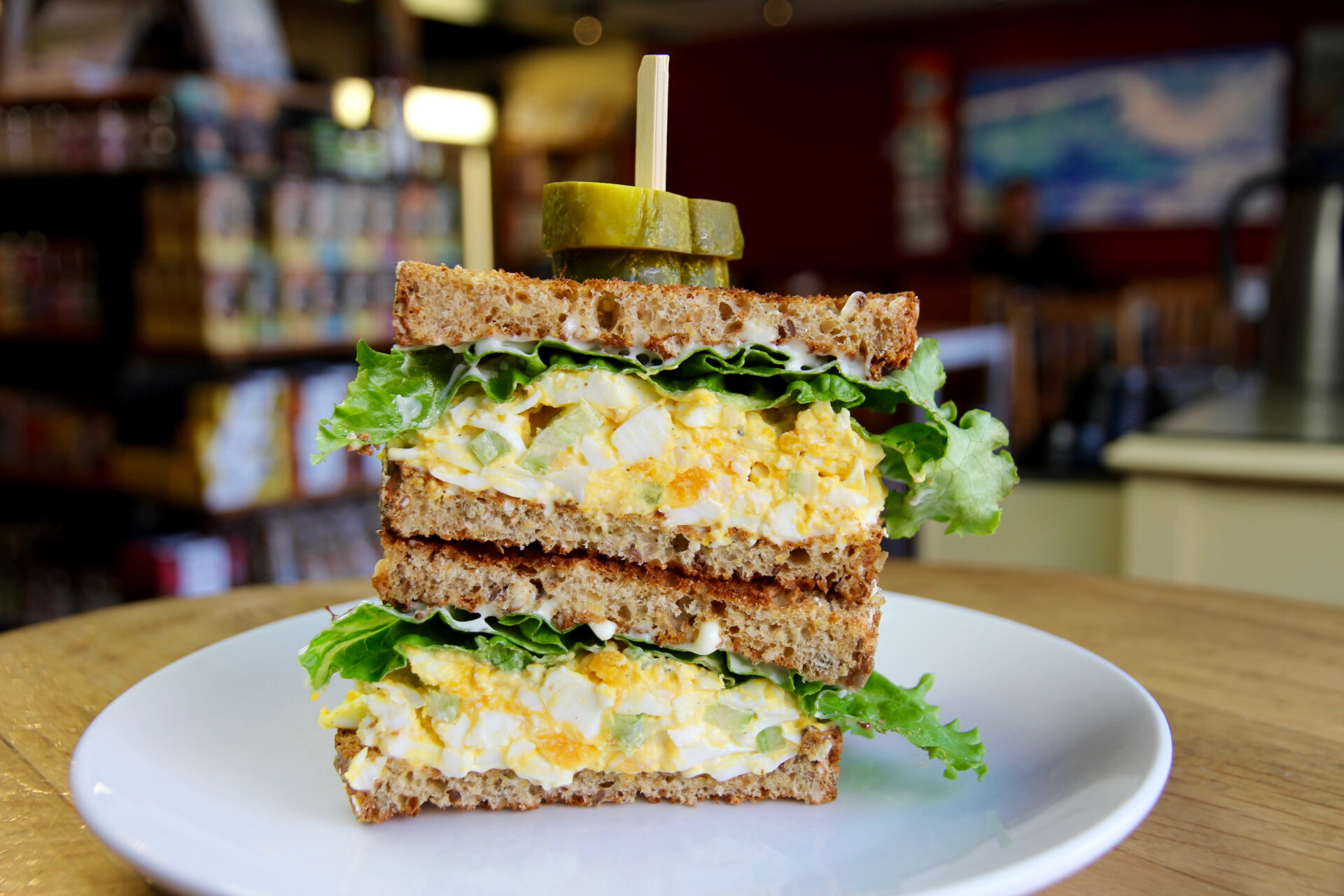 bench market egg sandwich with a pickle garnish