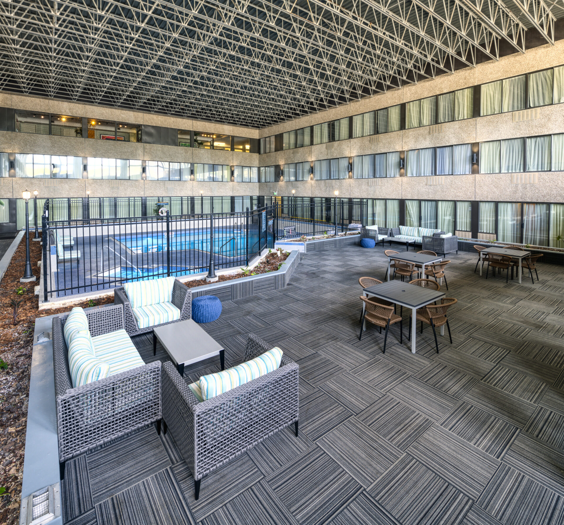 sandman hotel pool are with carpeting and seating
