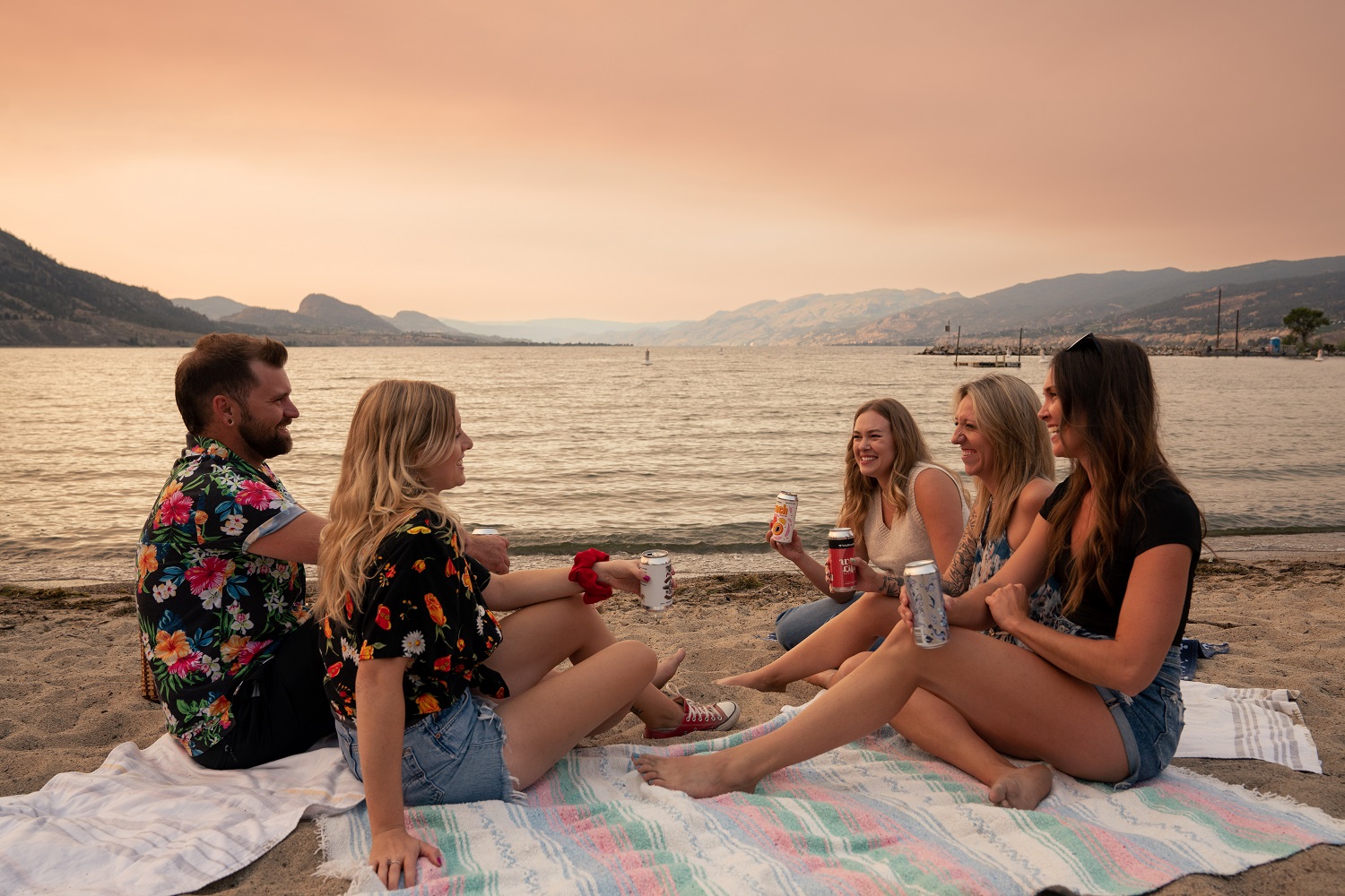 friends enjoying penticton ale trail beers on the beach