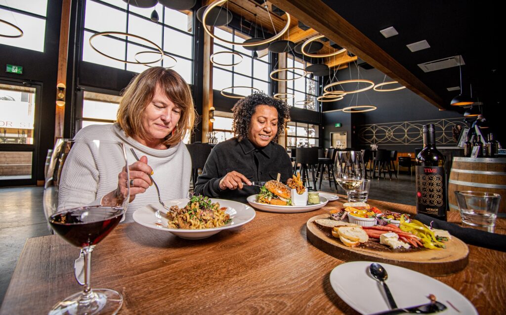 2 women enjoying a meal at time winery