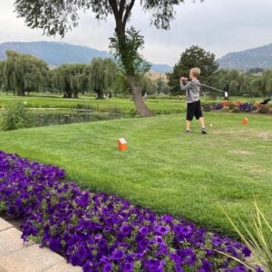 young boy teeing off at the Penticton Golf & Country Club