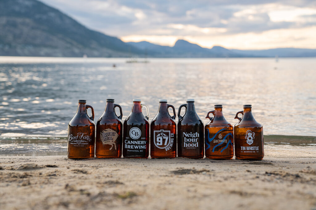 Penticton Ale Trail growlers sitting on Okanagan Beach