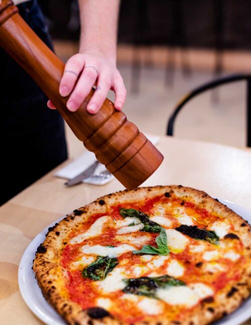 tratto pizza pepper being added from pepper mill