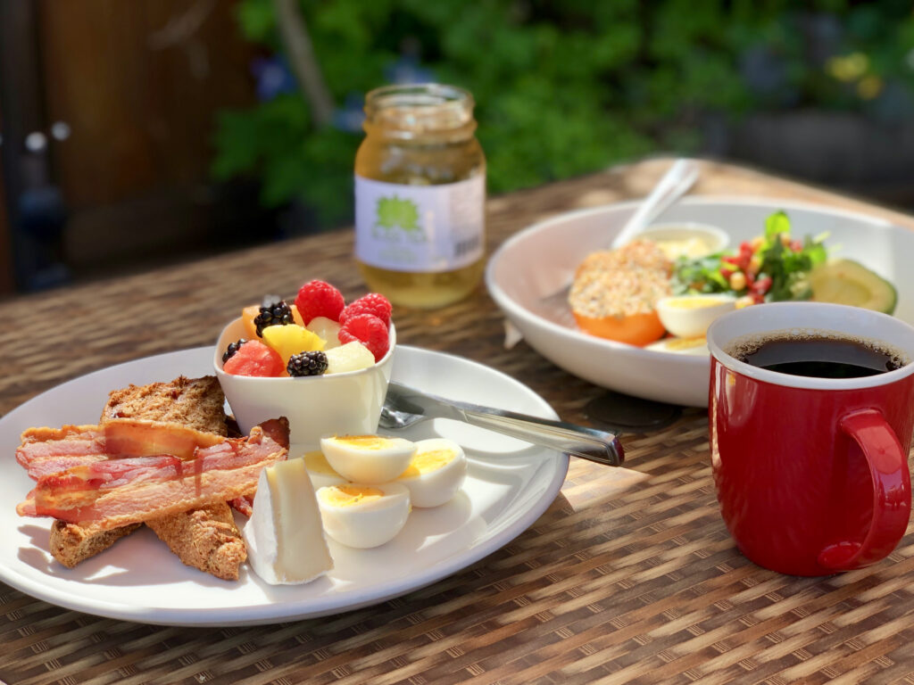 Brunch plates and coffee cup on The Bench Market's patio