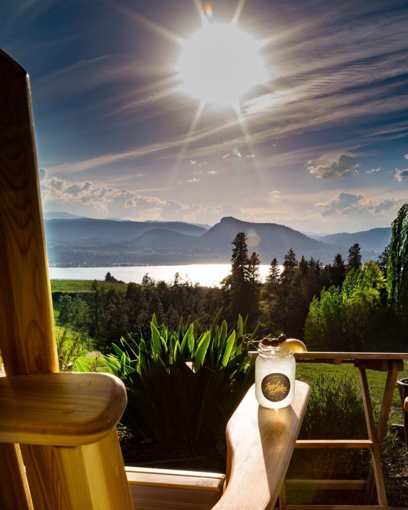 Cocktail sitting on a muskoka chair over looking okanagan lake