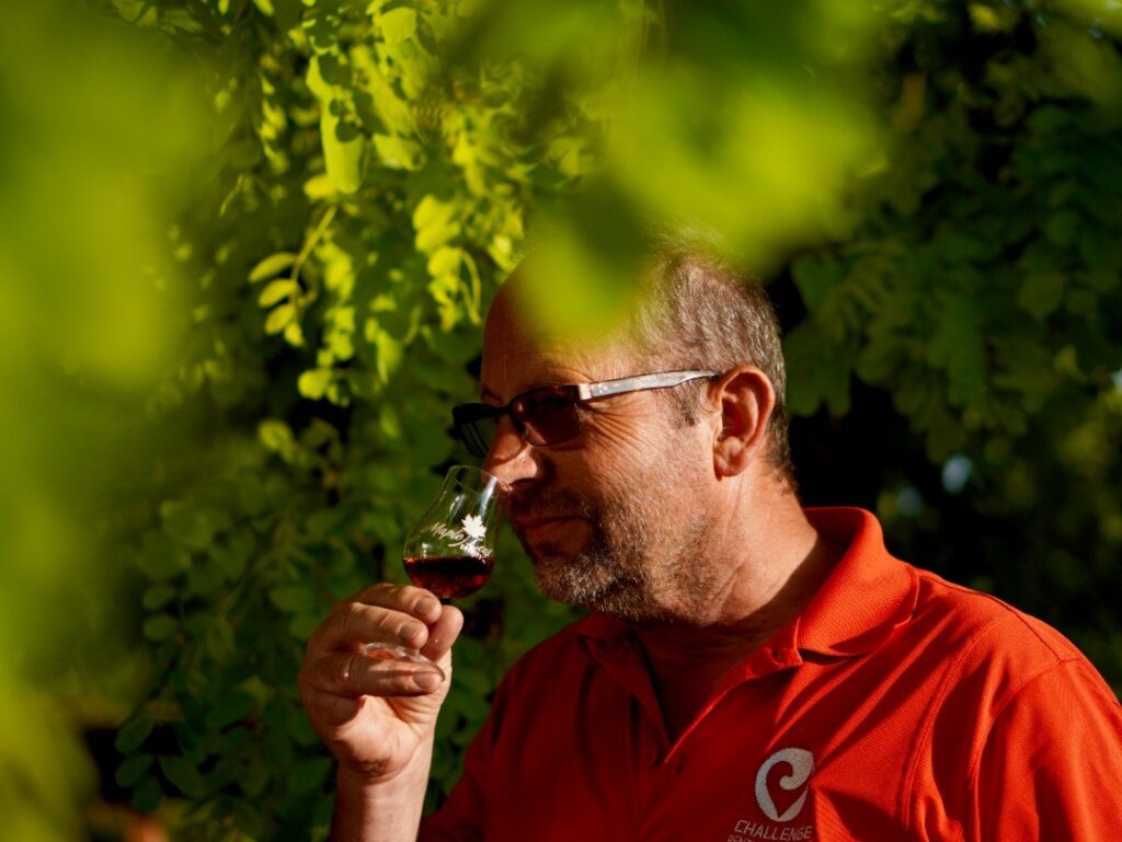 Maple Leaf Spirits co-owner Jorg sampling spirits under a tree