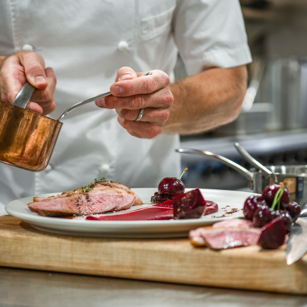 a chef preparing plate at Naramata Inn