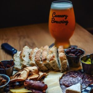 Charcuterie board and a pint of beer at Cannery Brewing