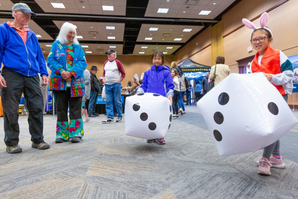 6th annual true penticton tourism expo rolling dice and having fun at a booth