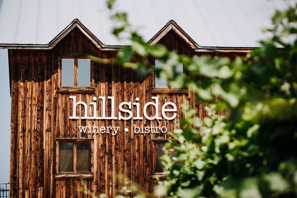 The side of the Hillside Winery building with the hillside winery bistro sign on it