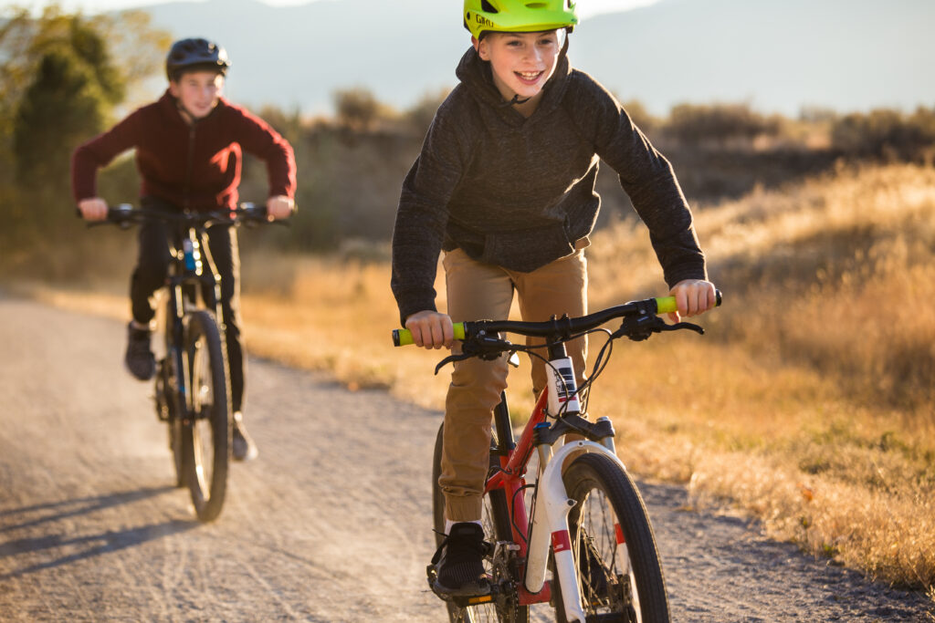 two boys on bikes smiling