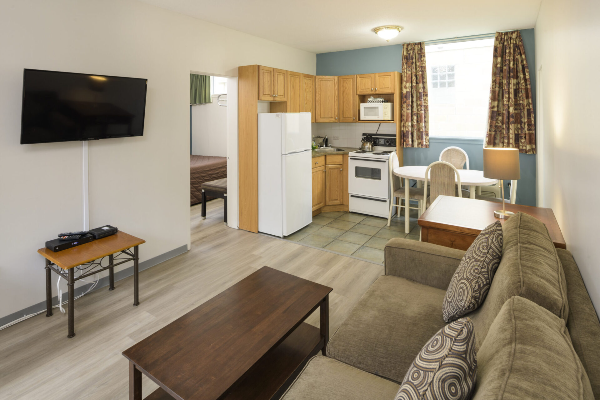 spanish villa motel room with living area and kitchen