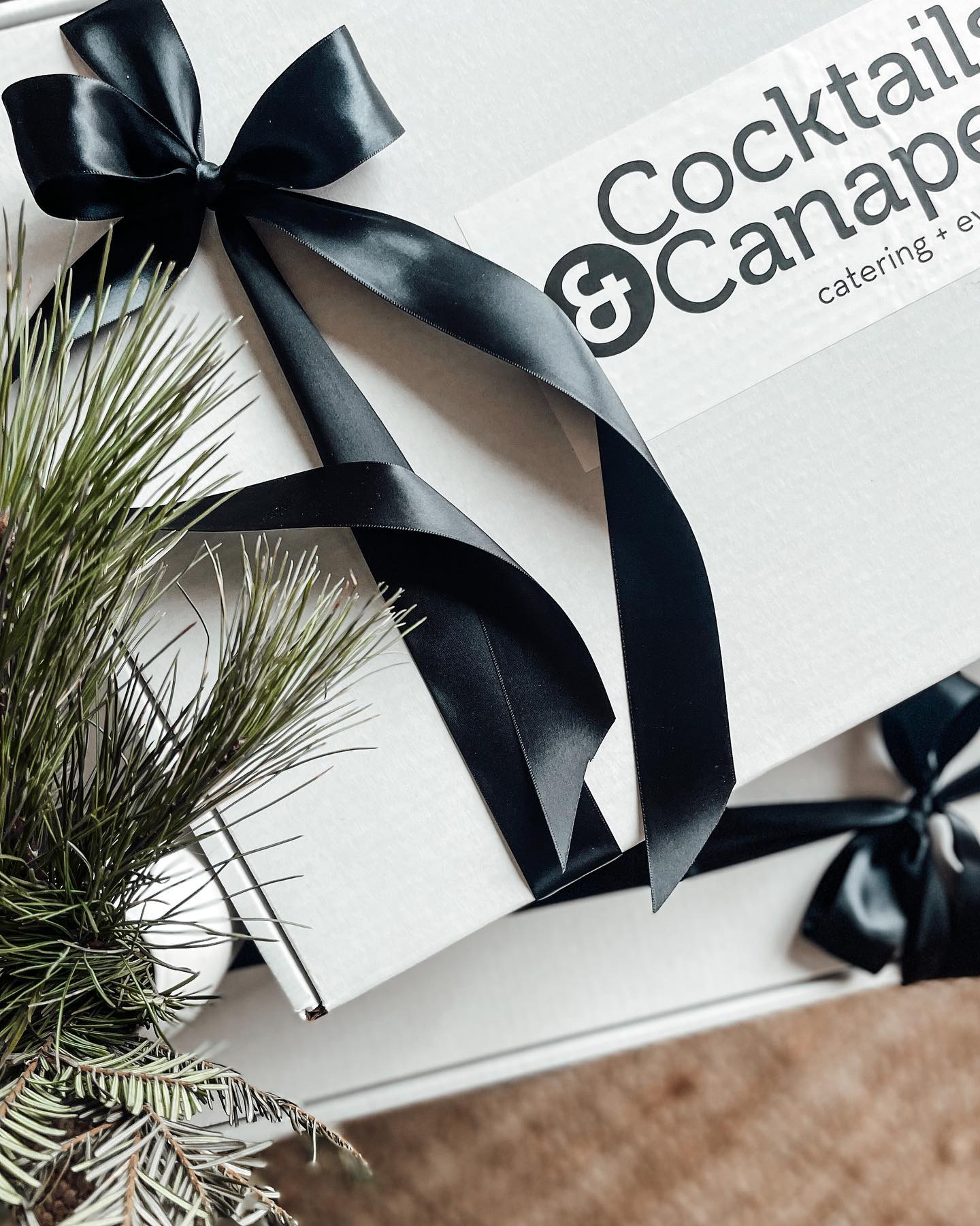 cocktails & canapes box wrapped in black ribbon