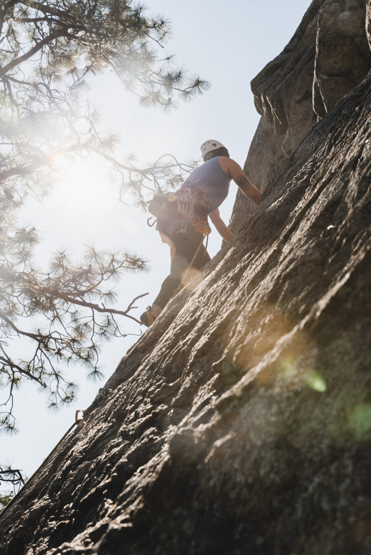 climber on the rocks in the sunshine at skaha bluffs