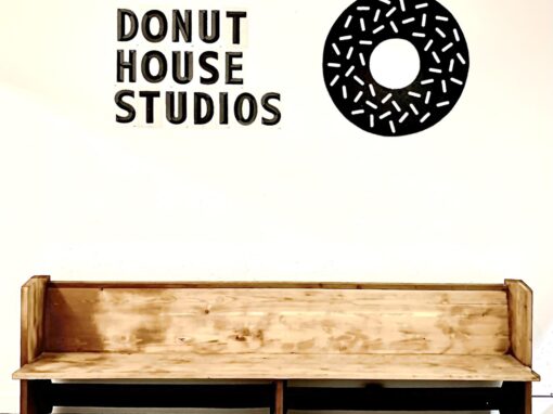 donut house studio sign over bench