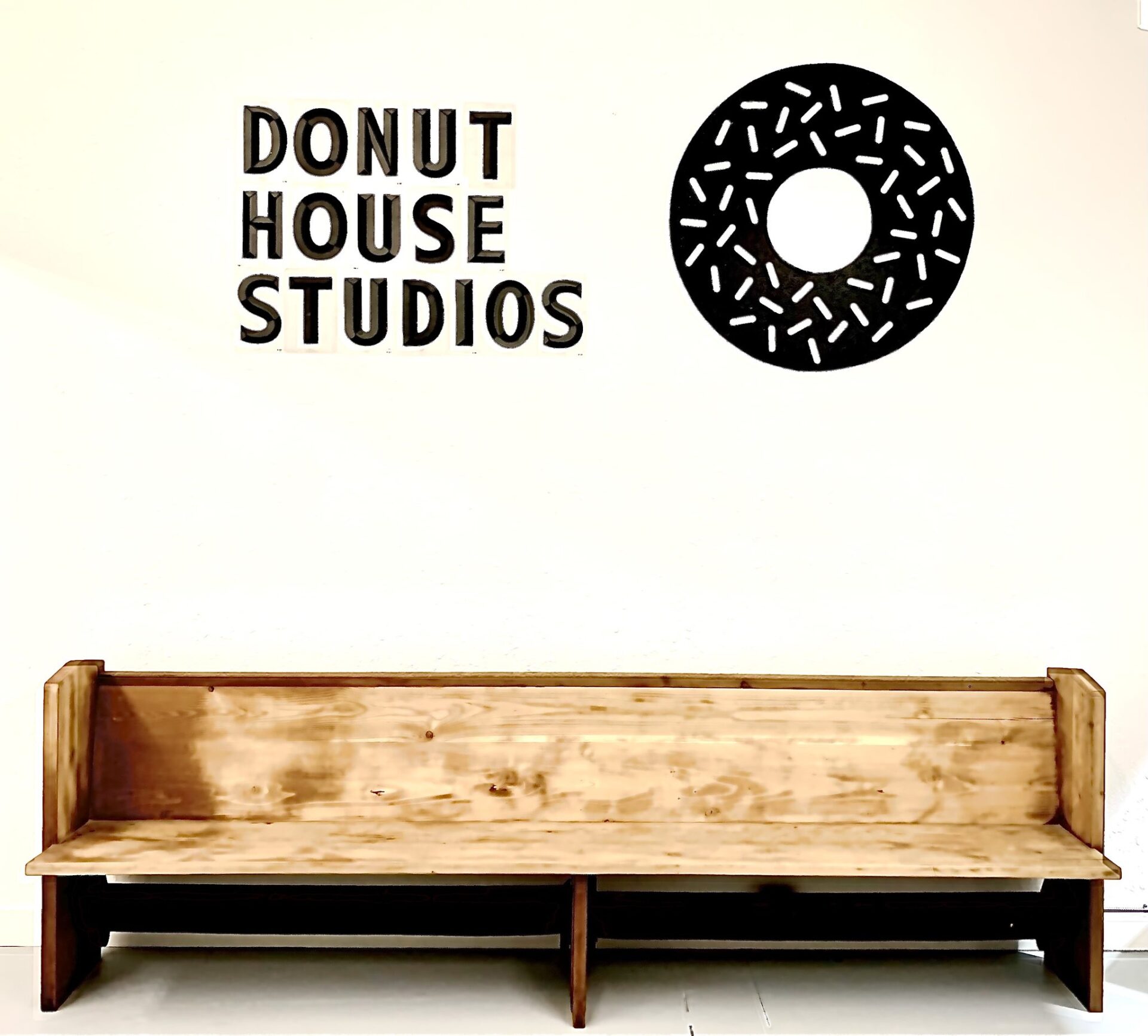 donut house studio sign over bench