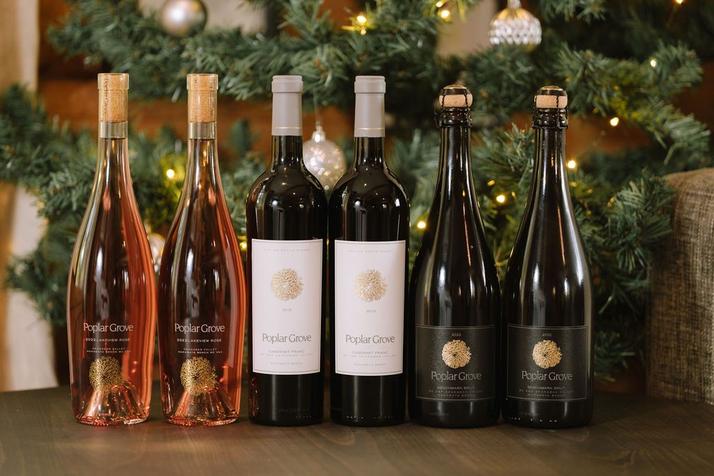 An assortment of Poplar Grove wines in front of a Christmas tree