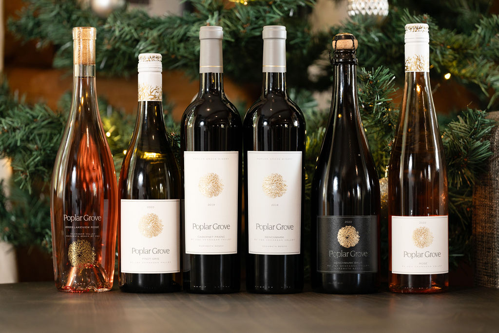 An assortment of Poplar Grove wines in front of a Christmas tree