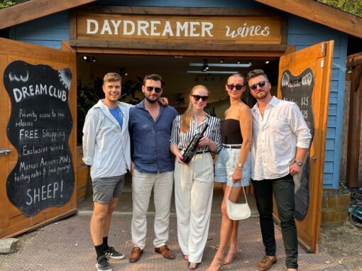 4 Guests along with Tasting Room Manager of Daydreamer Wines in Naramata, BC stand in front of the Wine Shack Tasting Room.