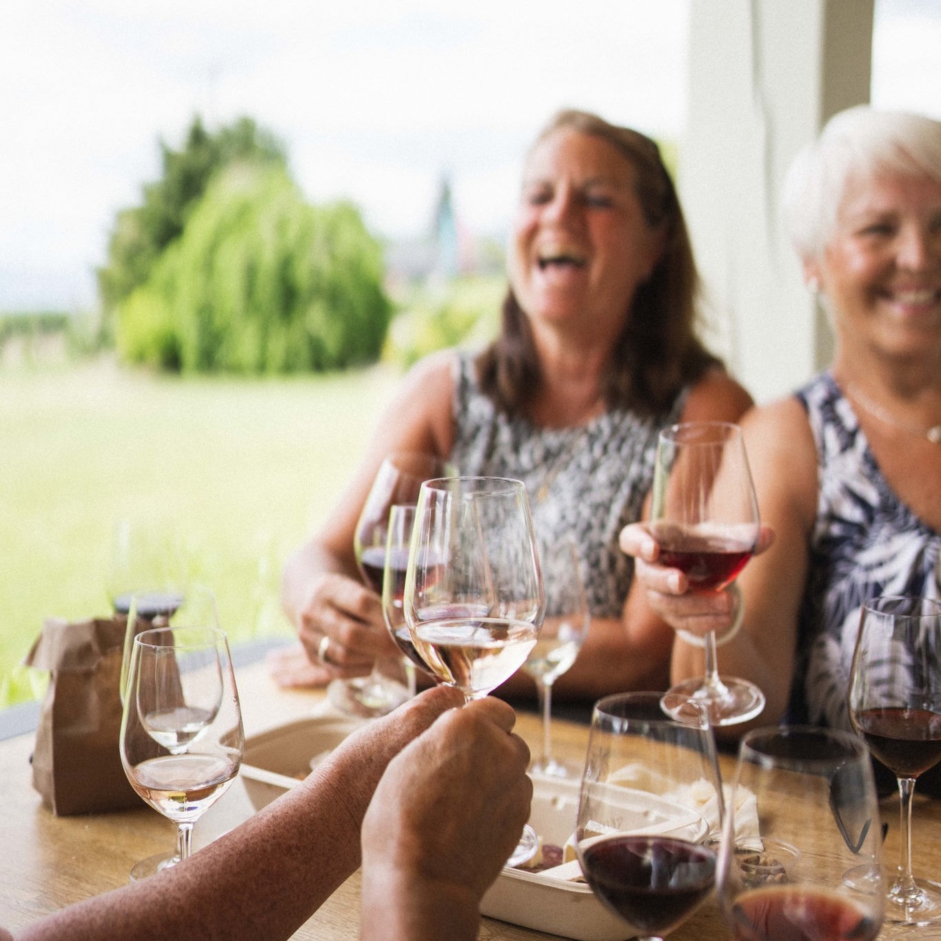 Red Rooster Winery ladies laughing with wine