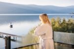 Sunset Sips & Snacks Wine Getaway Package at Summerland Waterfront Resort - guest overlooking the lake on the balcony